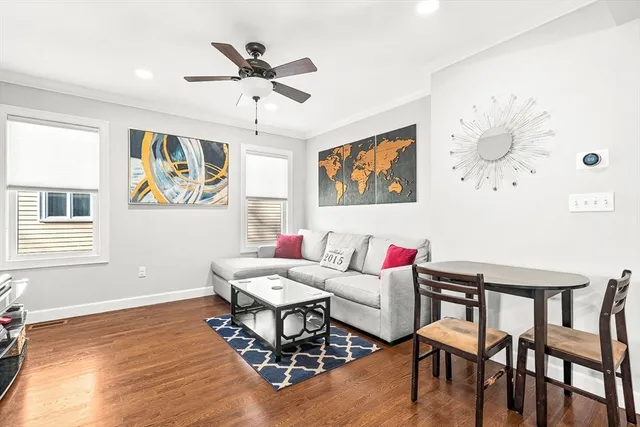 a living room with furniture and kitchen view