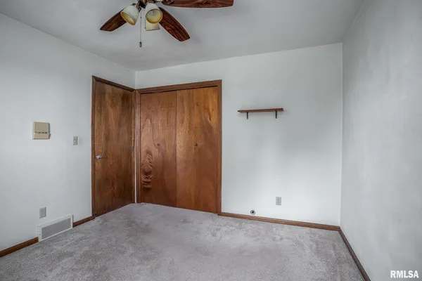a view of a room with a wooden door
