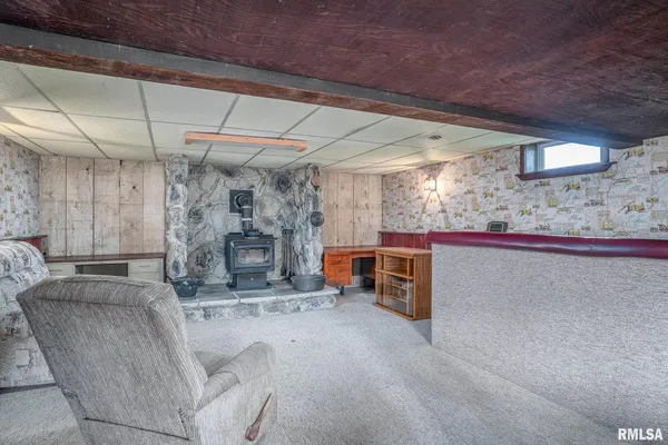 a view of a room with furniture and a fireplace
