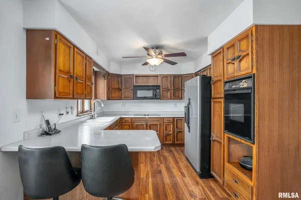 a kitchen with stainless steel appliances granite countertop a sink and a refrigerator