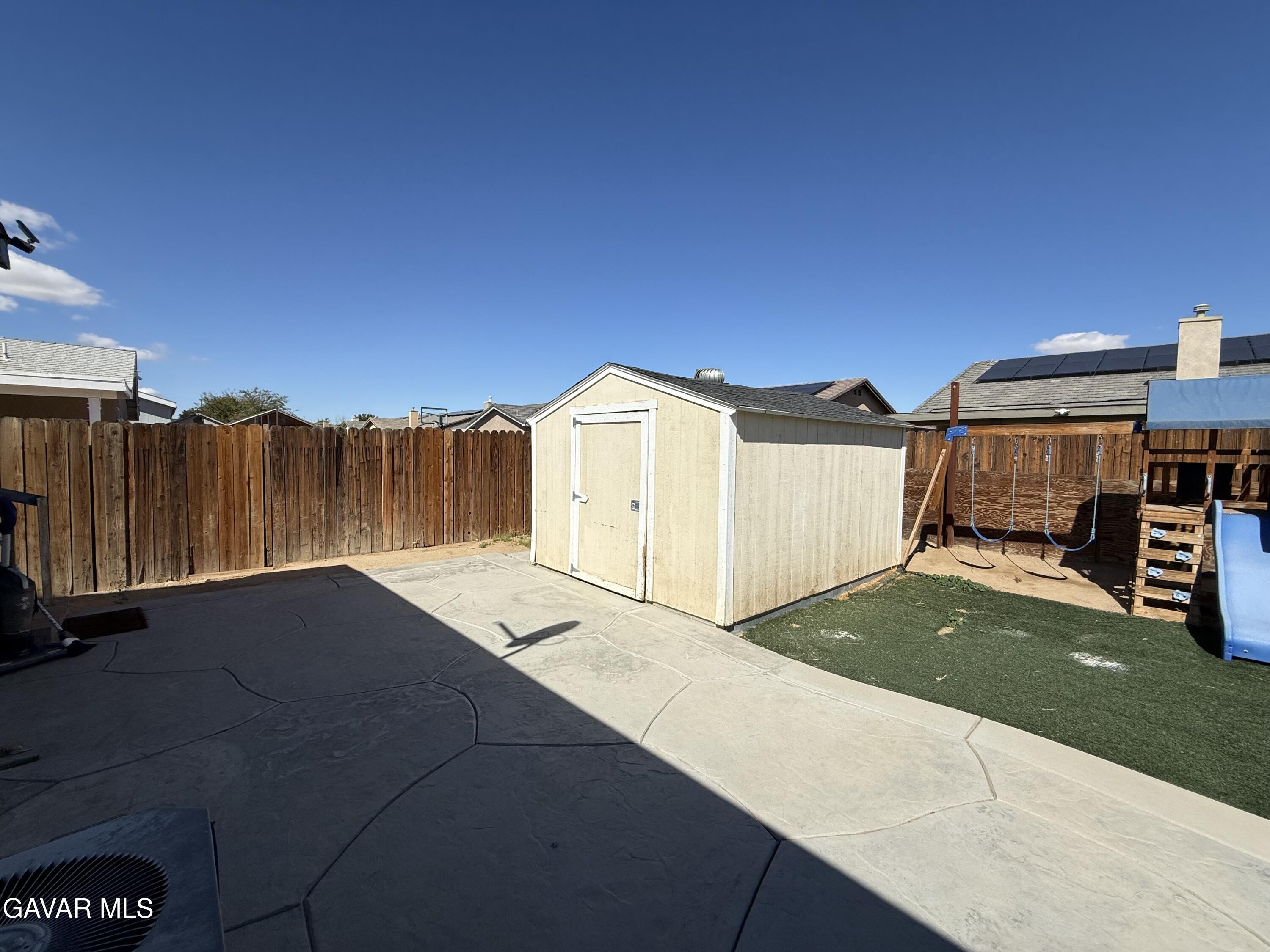 1365 Richfield Avenue Rosamond, CA 93560 - Photo 17 of 17 a view of a house with a backyard