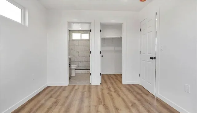 a view of empty room with wooden floor and cabinet