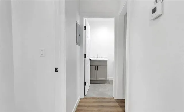 a view of a hallway with wooden floor and staircase