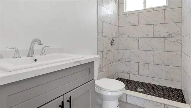 a bathroom with a sink toilet and shower