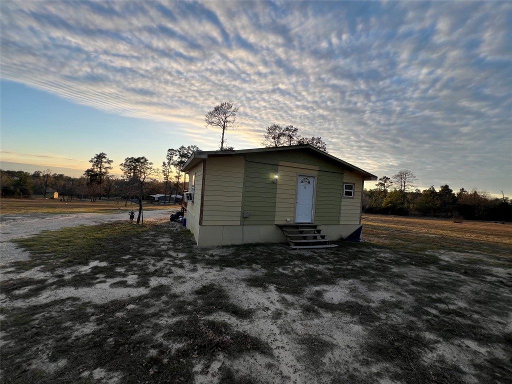 562 Pine Tree Loop, Unit B Bastrop, TX 78602 - Photo 18 of 18 a backyard of a house with lots of green space