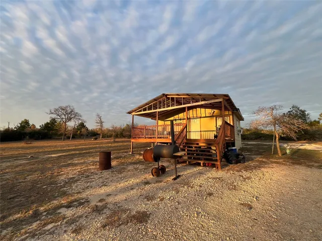 a backyard of a house with table and chairs