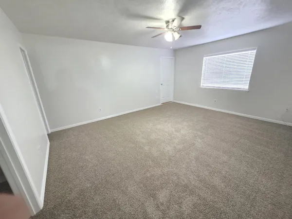 a white toilet sitting next to a white wall