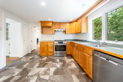 a kitchen with a stove a refrigerator and a sink