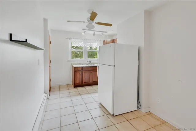 a view of kitchen with windows and cabinet