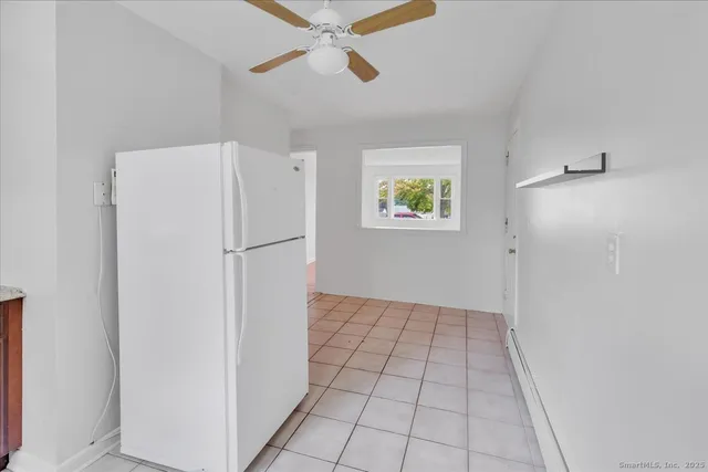 a view of an empty room with a kitchen
