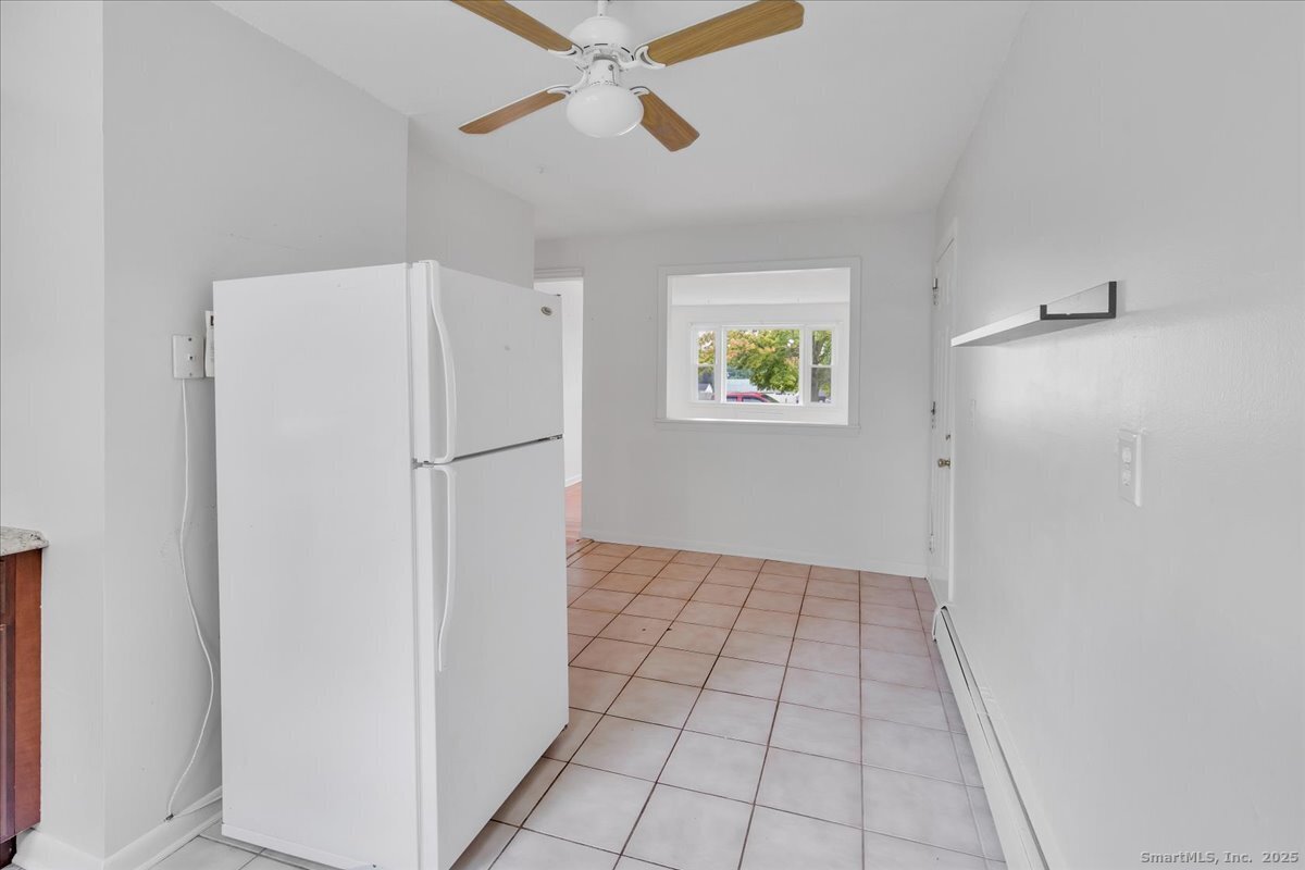 63 Maynard Street Middletown, CT 06457 - Photo 19 of 28 a view of an empty room with a kitchen