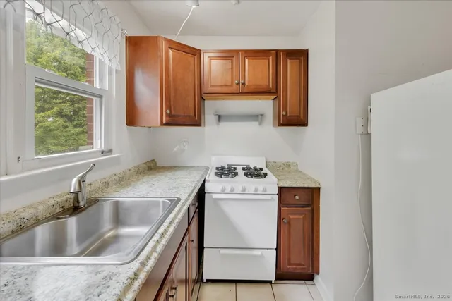 a kitchen with a stove a sink and a microwave