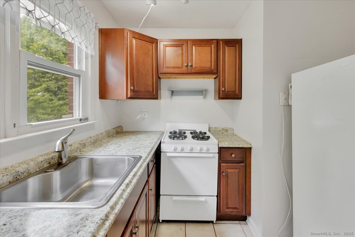 63 Maynard Street Middletown, CT 06457 - Photo 20 of 28 a kitchen with a stove a sink and a microwave
