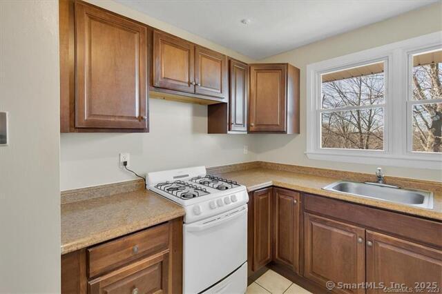 63 Maynard Street Middletown, CT 06457 - Photo 4 of 28 a kitchen with stainless steel appliances granite countertop a sink stove and cabinets