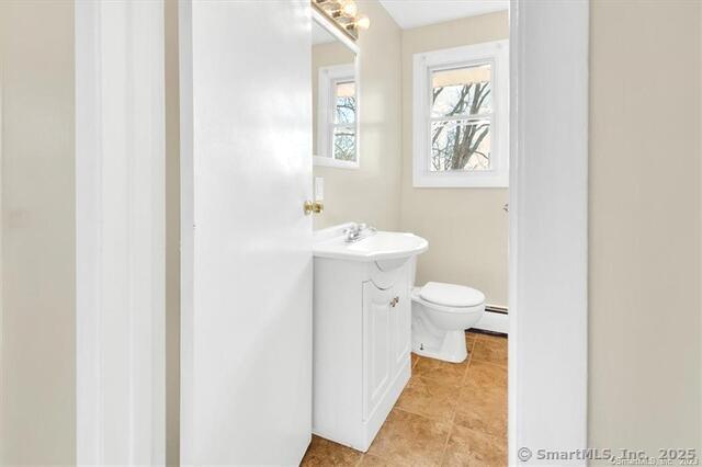 63 Maynard Street Middletown, CT 06457 - Photo 5 of 28 a bathroom with a toilet sink and mirror