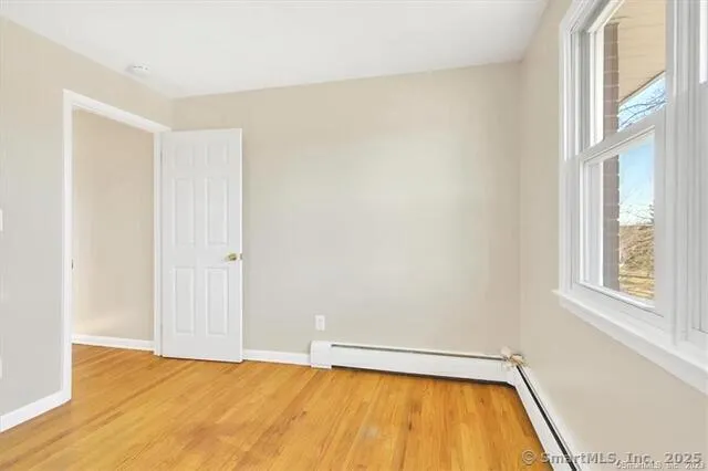 a view of a room with a wooden floor and a window