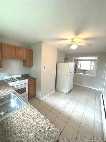 a kitchen with a sink a stove and cabinets
