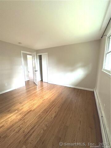 63 Maynard Street Middletown, CT 06457 - Photo 9 of 28 an empty room with wooden floor and windows
