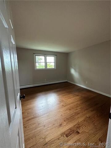 63 Maynard Street Middletown, CT 06457 - Photo 10 of 28 an empty room with wooden floor and windows