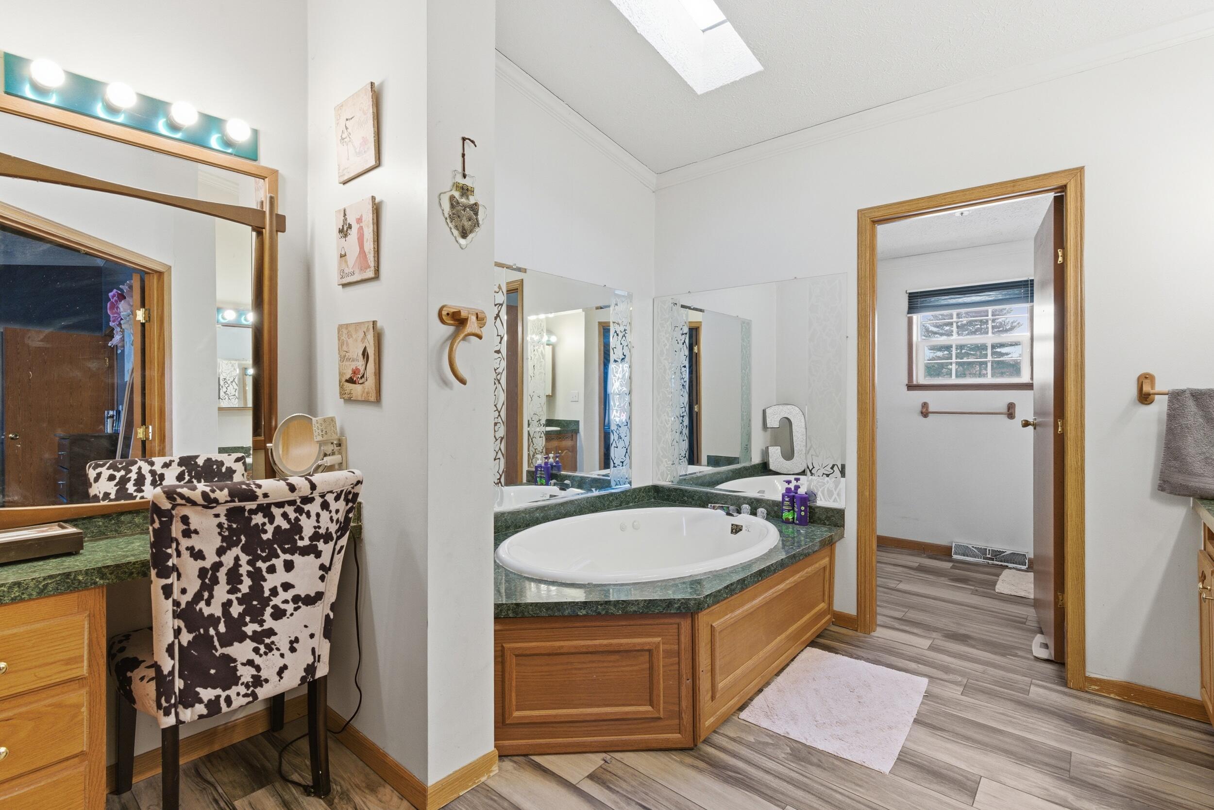 4827 East 994 North Demotte, IN 46310 - Photo 16 of 25 a spacious bathroom with a double vanity sink a mirror and shower
