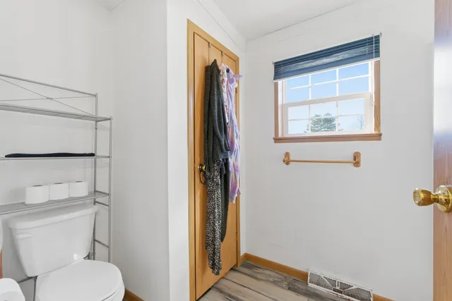 a bathroom with a toilet and a shower