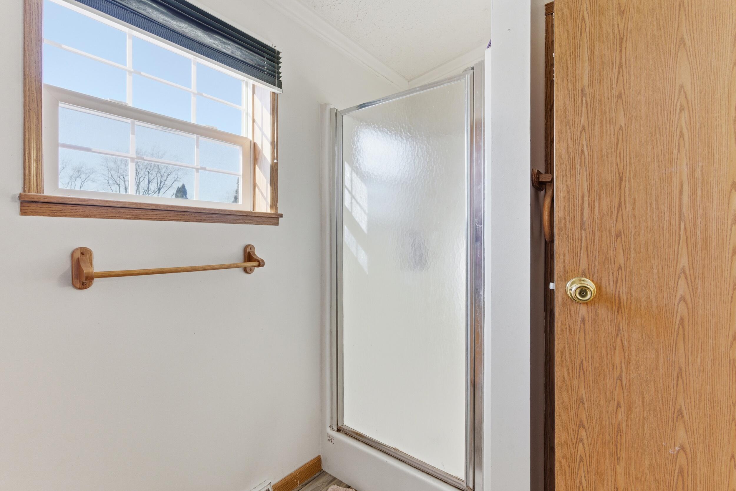 4827 East 994 North Demotte, IN 46310 - Photo 19 of 25 a bathroom with a shower and a window