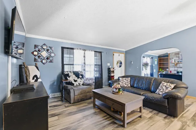 a living room with furniture flat screen tv and a fireplace