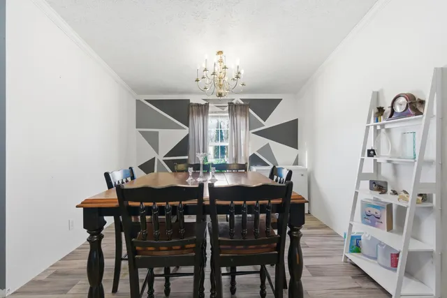 a view of a dining room with furniture and chandelier