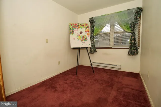 an empty room with windows and wall