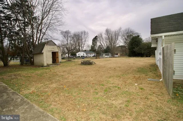 an aerial view of a house with garden space and a car park