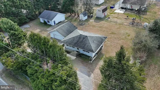 an aerial view of a house with a yard basket ball court and outdoor seating