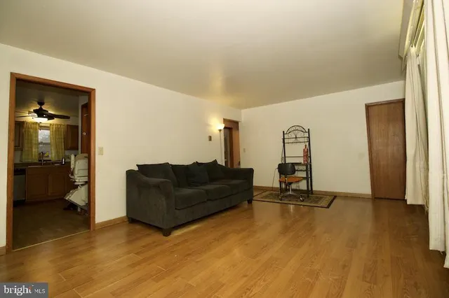 a living room with furniture and a mirror