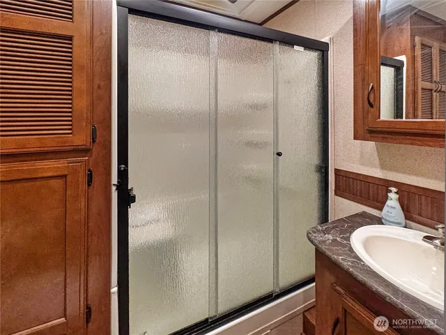 a bathroom with a glass shower door