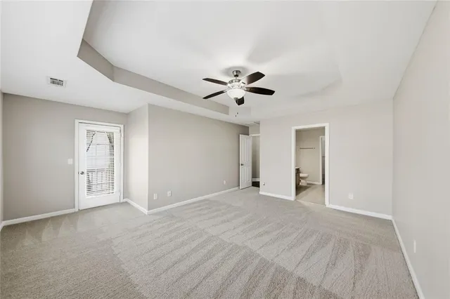 a view of an empty room with a ceiling fan