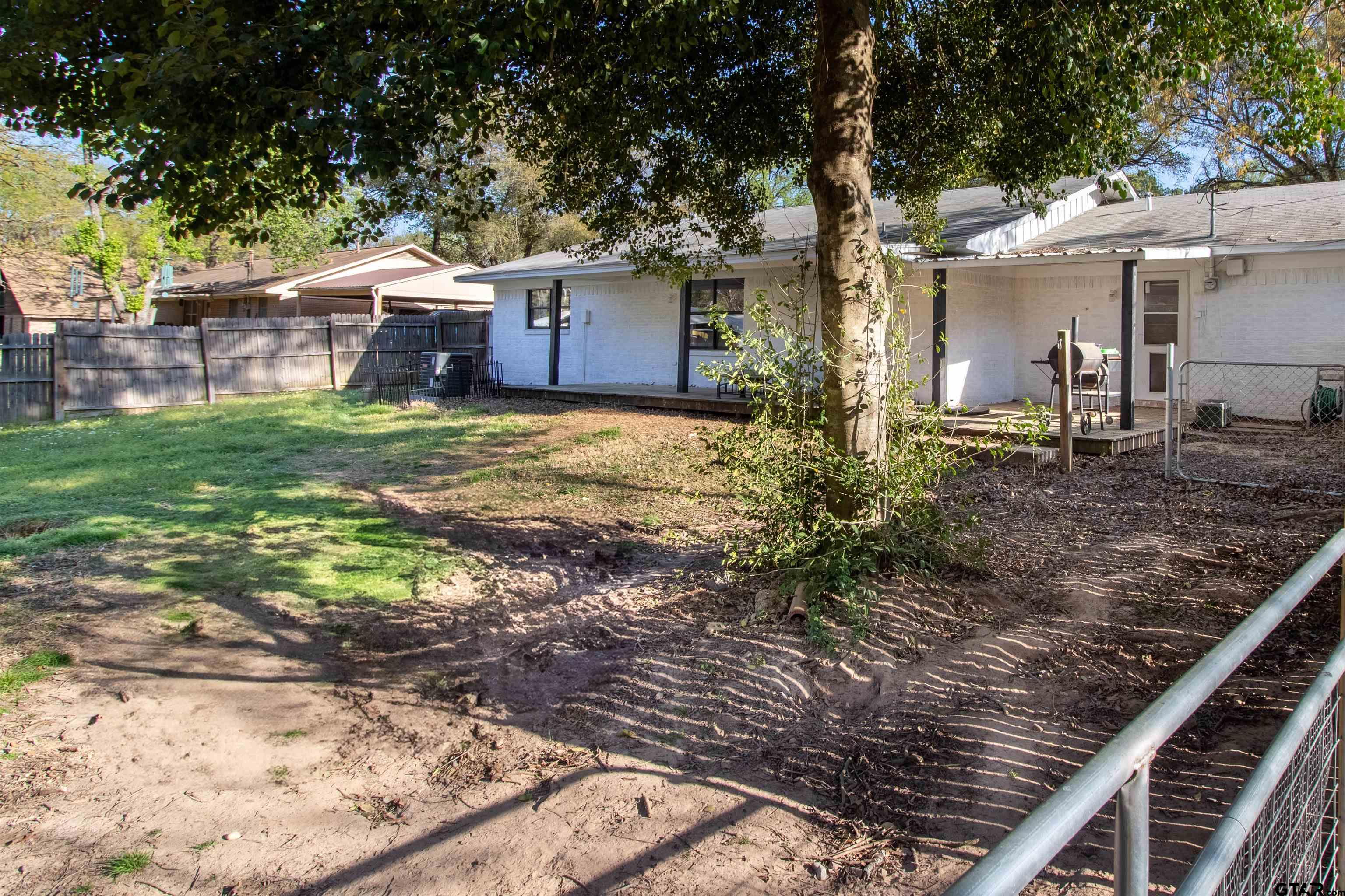 513 Lance Road Quitman, TX 75783 - Photo 23 of 27 a couple of flower plants sitting in front of a house