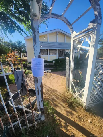 a view of a patio with table and chairs and floor to ceiling window