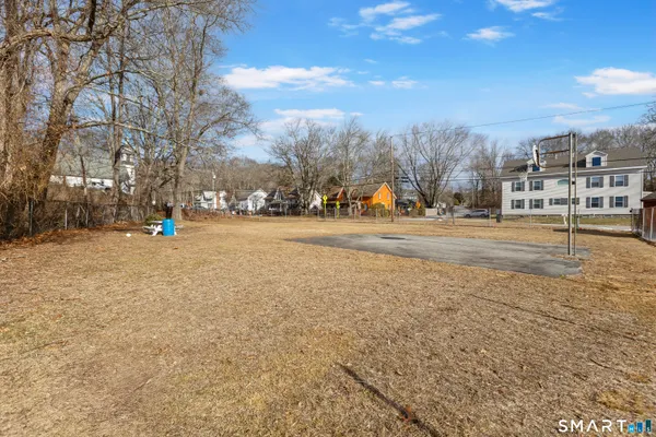 a view of dirt yard with a house
