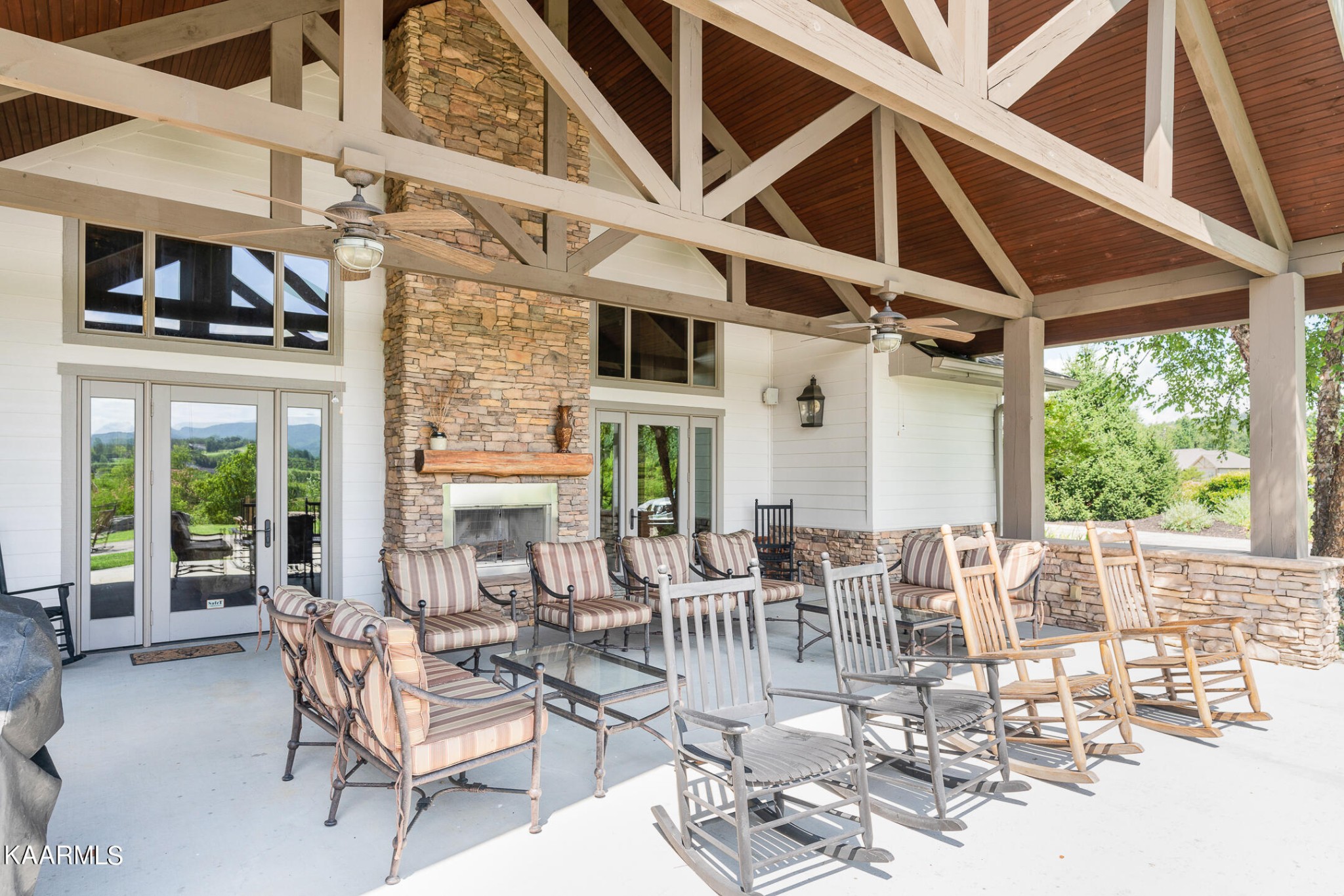 326 Shooting Star Loop, Unit 106 Townsend, TN 37882 - Photo 20 of 24 a view of a patio with table and chairs potted plants with floor to ceiling window