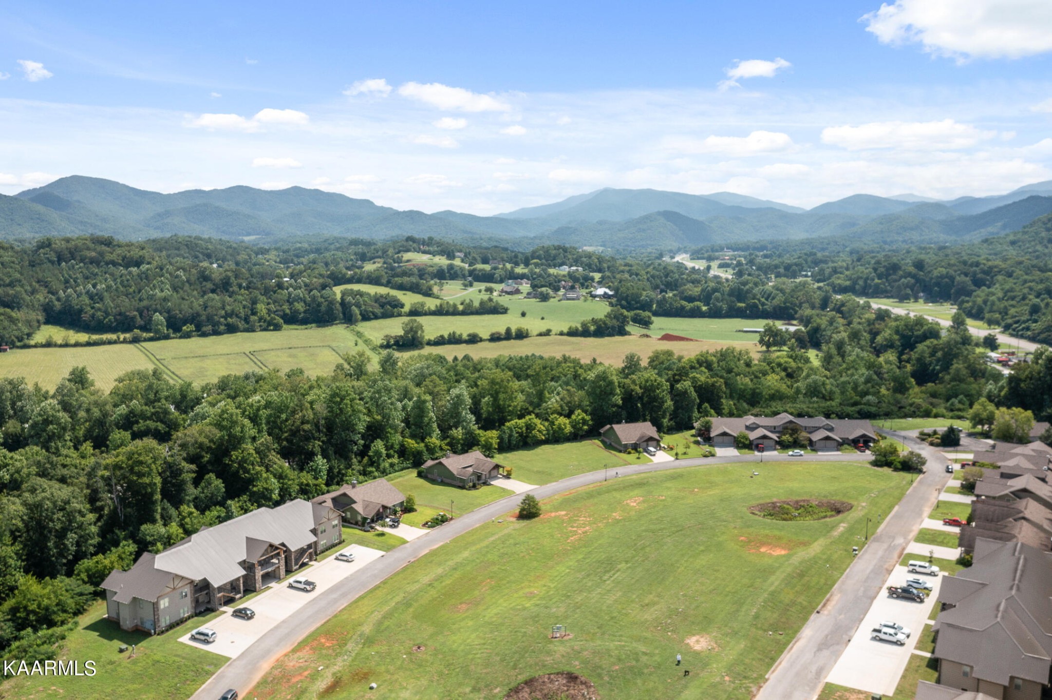 326 Shooting Star Loop, Unit 106 Townsend, TN 37882 - Photo 22 of 24 a view of a lush green hillside and houses