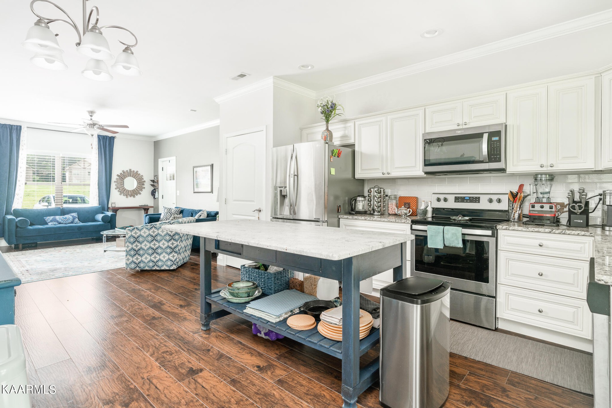 326 Shooting Star Loop, Unit 106 Townsend, TN 37882 - Photo 7 of 24 a kitchen with stainless steel appliances kitchen island granite countertop a stove and cabinets