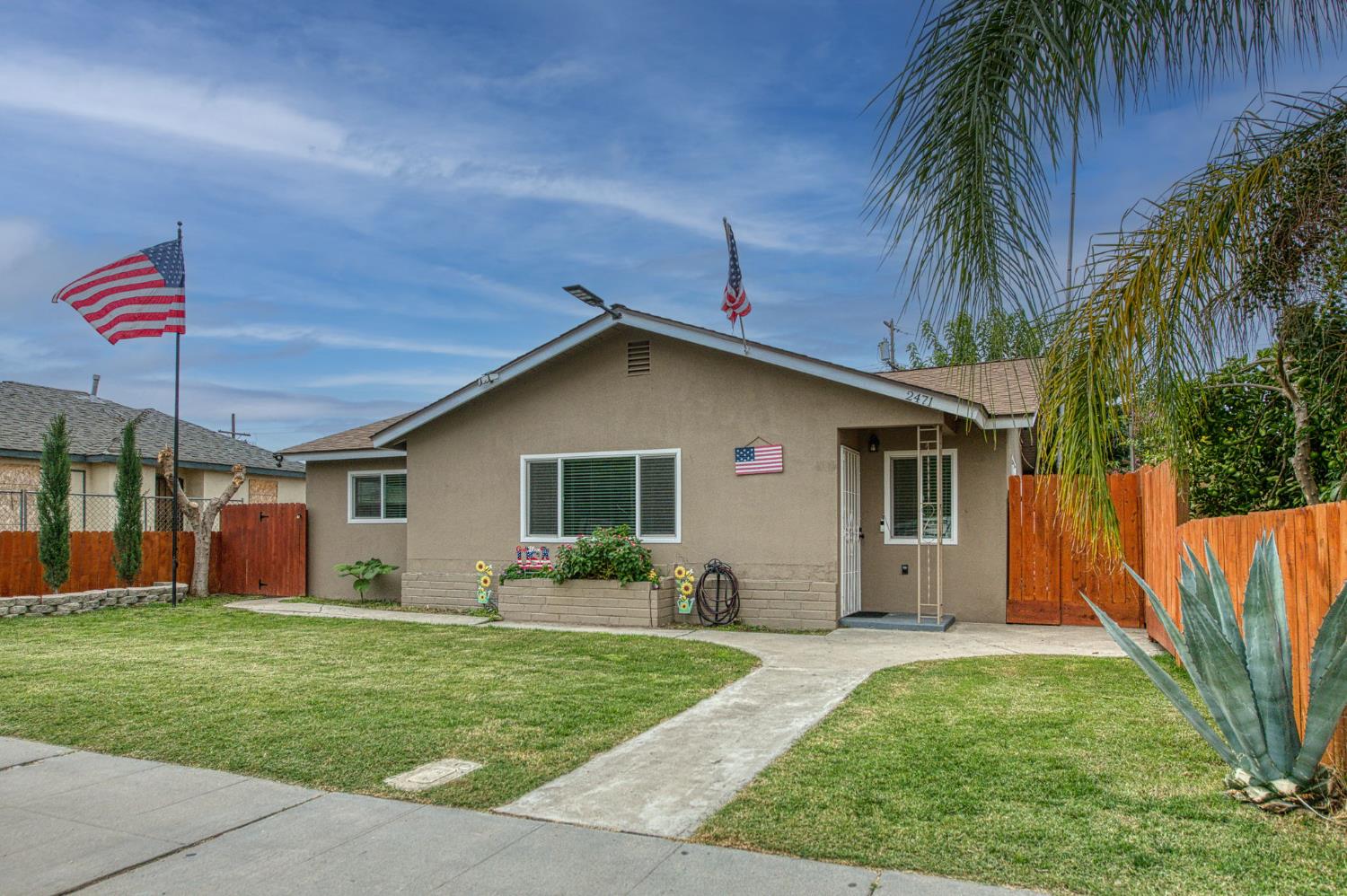 a front view of house with yard and outdoor seating