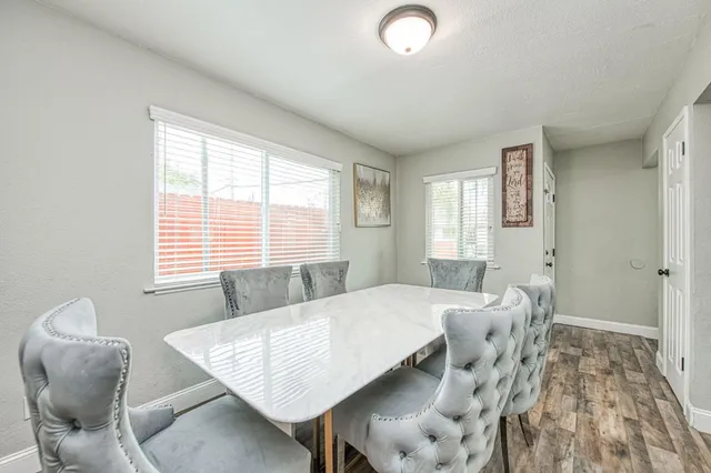 a view of a dining room with furniture and wooden floor