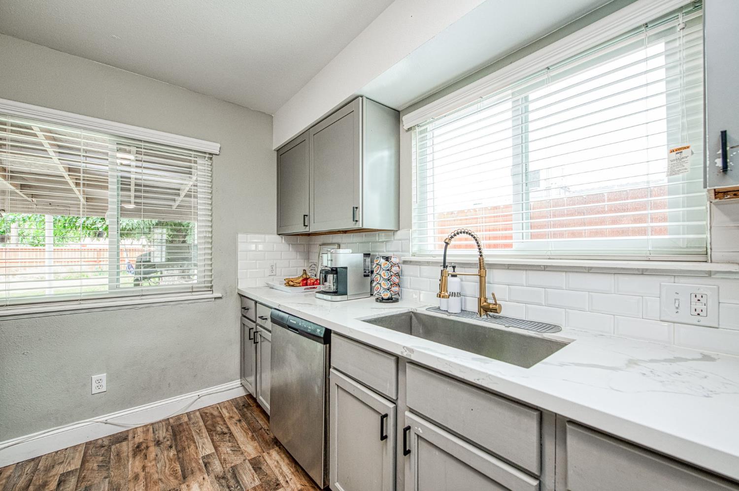 2471 Nebraska Avenue Selma, CA 93662 - Photo 14 of 29 a kitchen with kitchen island a sink a window and cabinets
