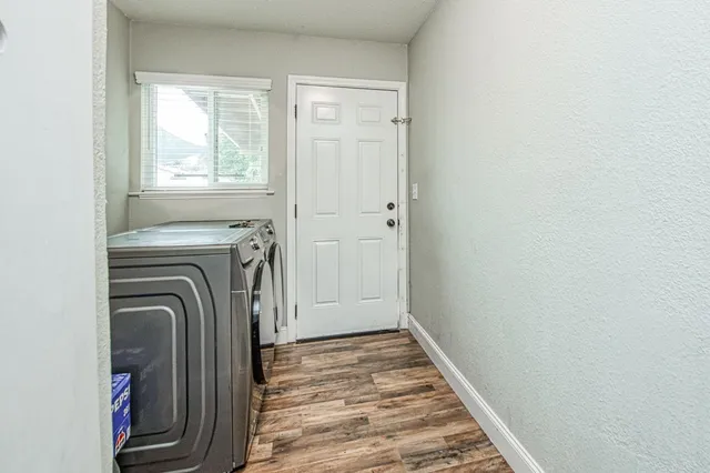 a view of a bedroom with washer and dryer