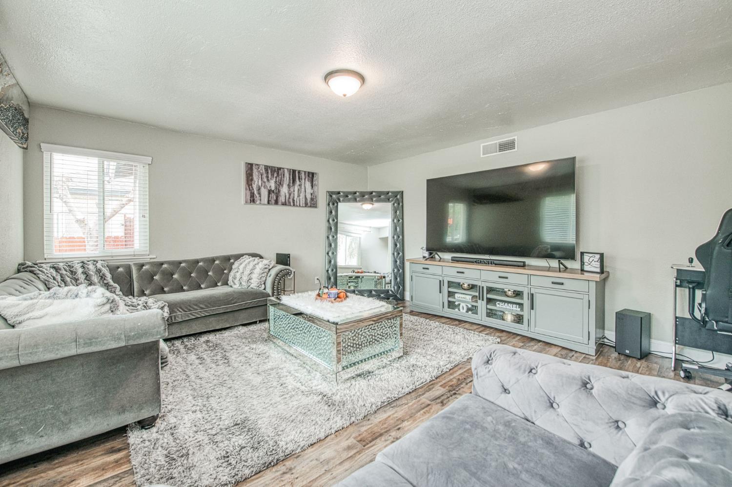 2471 Nebraska Avenue Selma, CA 93662 - Photo 8 of 29 a living room with furniture and a flat screen tv