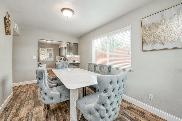 a view of a dining room with furniture window and wooden floor