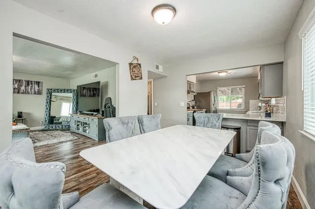 a living room with furniture a wooden floor and a large window