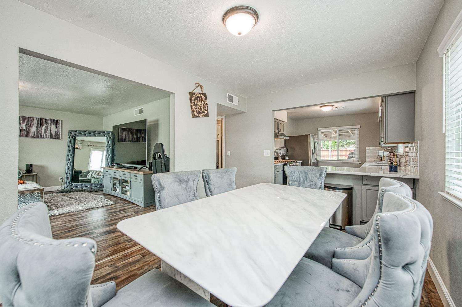 2471 Nebraska Avenue Selma, CA 93662 - Photo 10 of 29 a living room with furniture a wooden floor and a large window