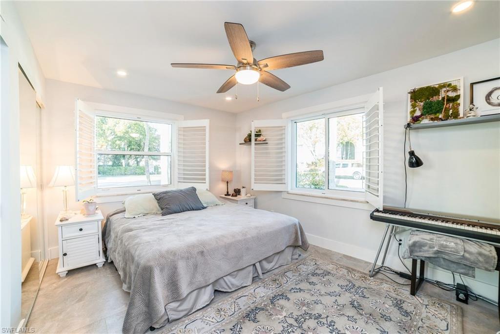 980 7th Avenue South, Unit 101 Naples, FL 34102 - Photo 14 of 32 a bedroom with a bed and a window