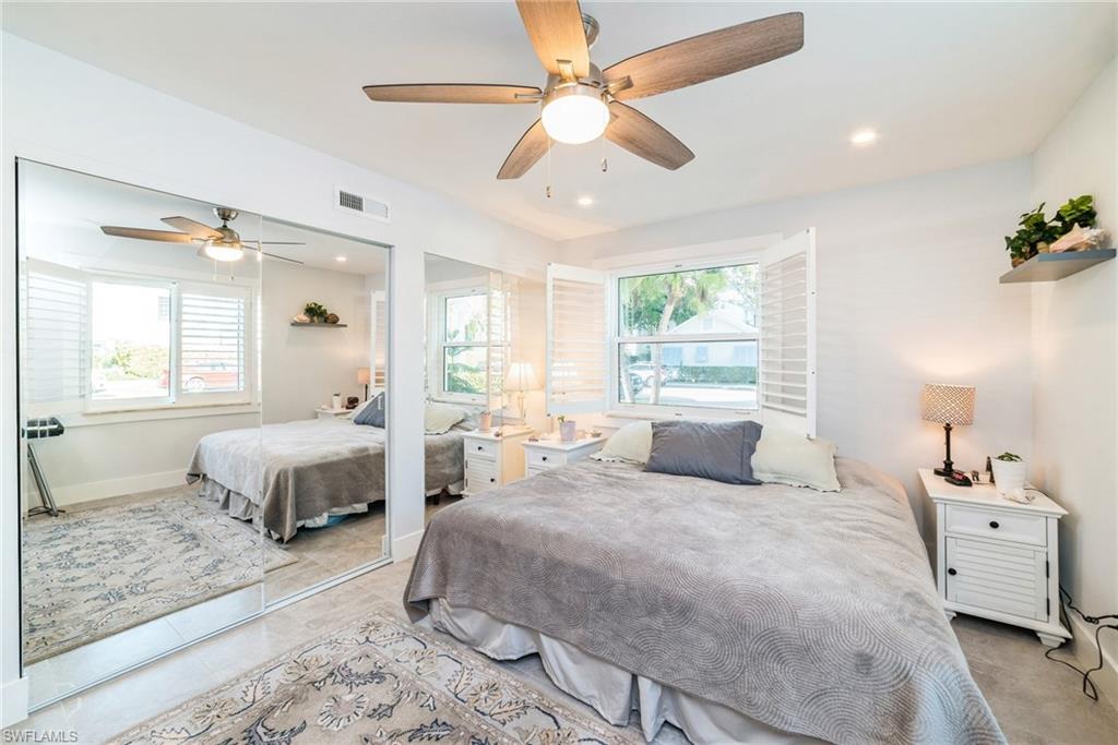 980 7th Avenue South, Unit 101 Naples, FL 34102 - Photo 16 of 32 a bedroom with a large bed and a window